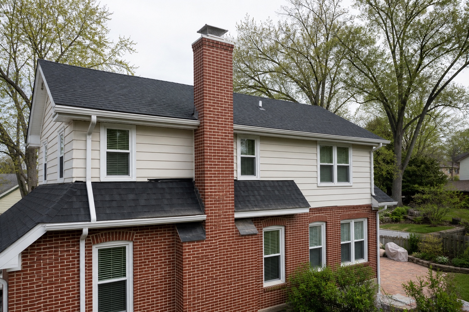 Restored brick chimney with clean mortar on a Midwest home